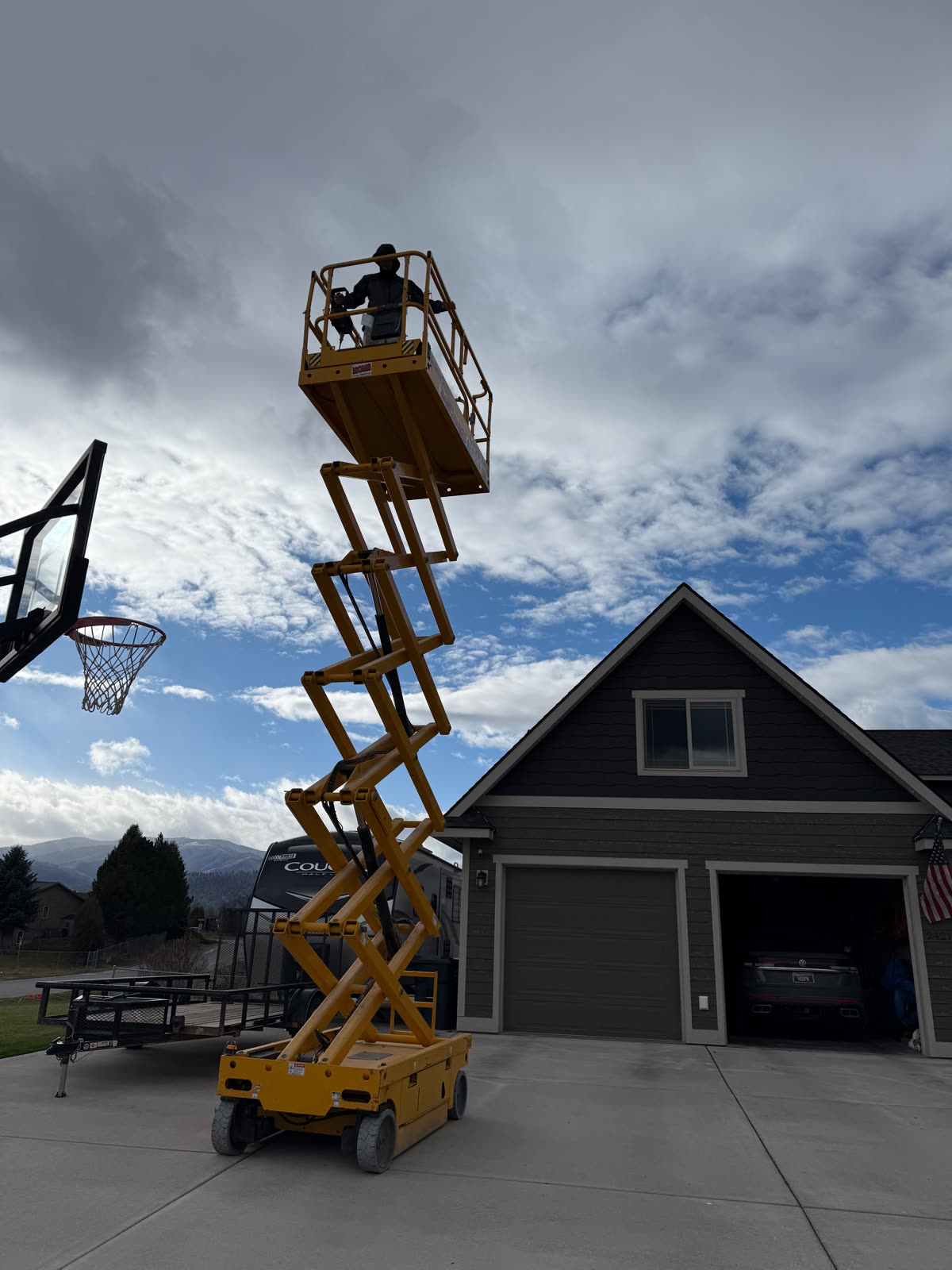 Scissor lift install on a two-story gable by Montana Lights